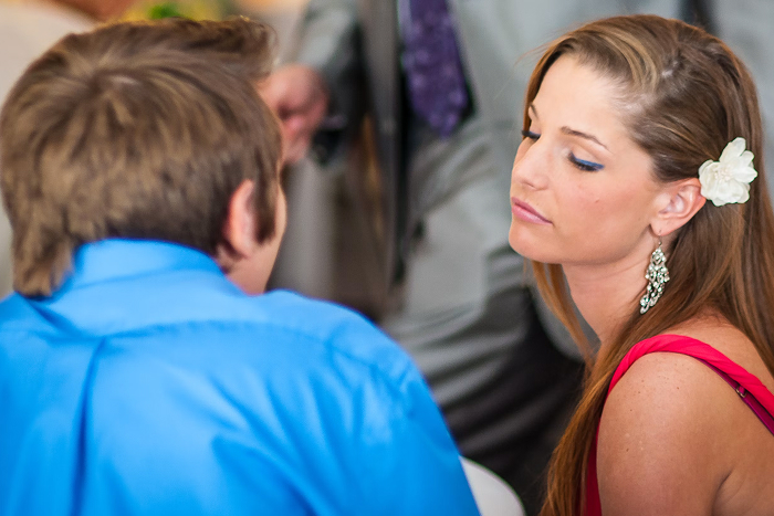A woman with a flower in her hair looks away from a man, illustrating exasperation from mansplaining examples.