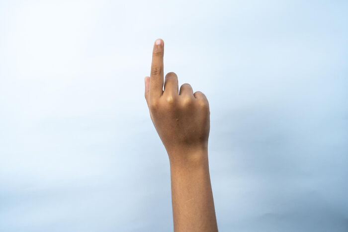 A person's hand with the index finger pointing upwards on a light background, symbolizing a fact or point. This image represents facts people wish they could forget.