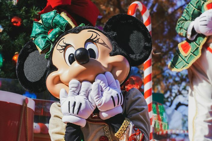 Minnie Mouse covers her mouth with her hands, as if reacting to facts people wish they could forget.