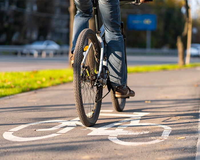 A person riding a bicycle on a designated bike lane, highlighting proper cycling etiquette. A person riding a bicycle on a designated bike lane, highlighting proper cycling etiquette.