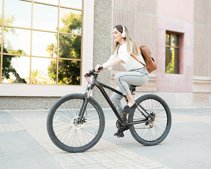 A young woman cycling with headphones, illustrating a peaceful ride, contrasting with the cyclist Karen's behavior. A young woman cycling with headphones, illustrating a peaceful ride, contrasting with the cyclist Karen's behavior.
