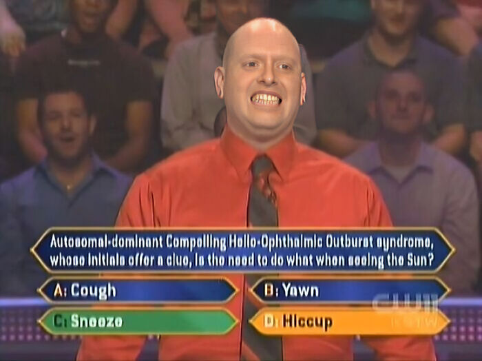 A contestant makes a funny face with a dumb Who Wants To Be A Millionaire question about a syndrome causing sneezing in the sun.