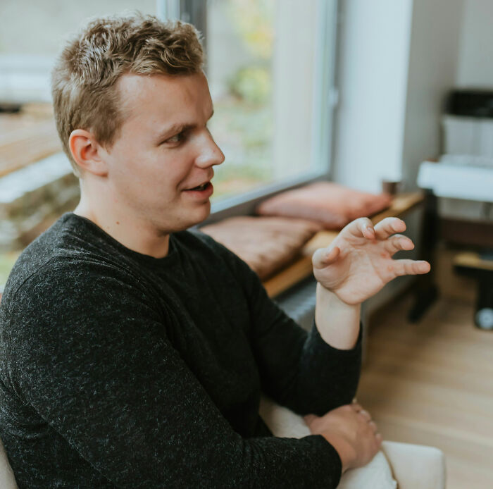 A man talking animatedly, illustrating subtle signs someone isn't as nice as they pretend to be.