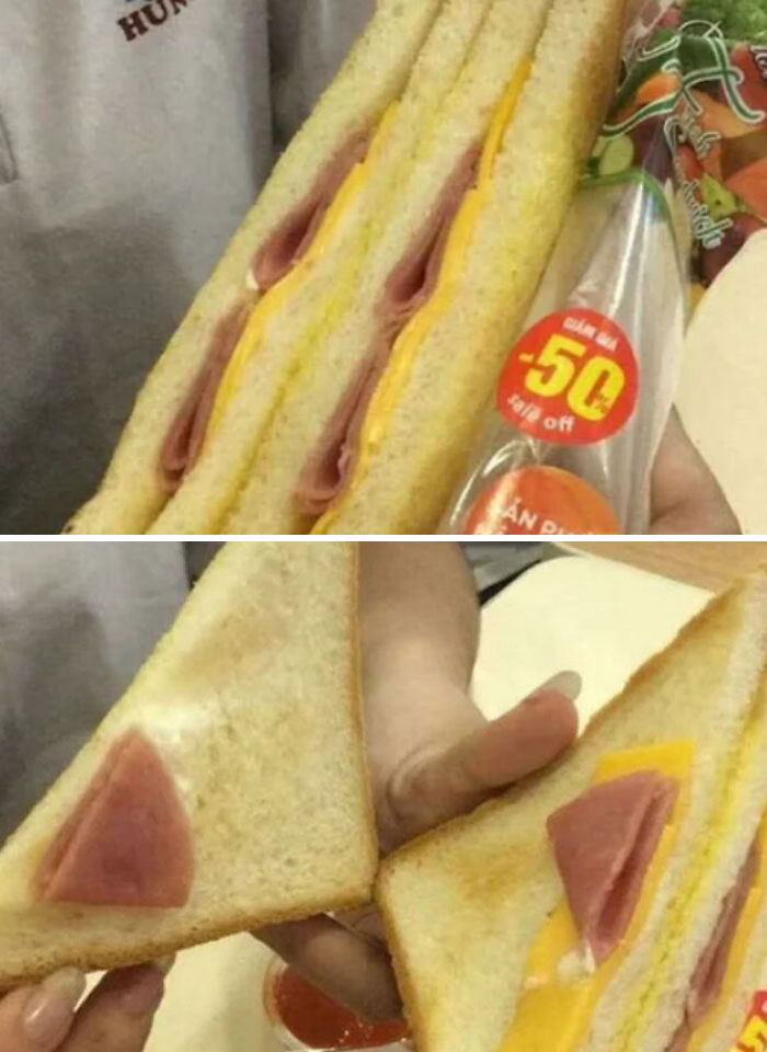 Sandwich with minimal ham and cheese filling compared to its packaging, highlighting infuriating marketing practices.