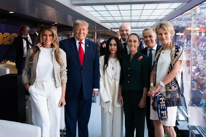 Donald Trump with Melania and others, fueling a body double conspiracy theory due to a background detail. Donald Trump with Melania and others, fueling a body double conspiracy theory due to a background detail.