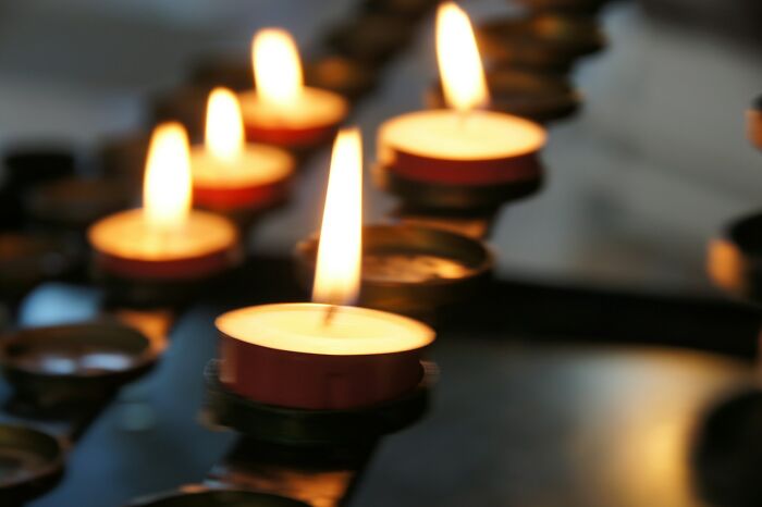 Multiple lit candles in a dark setting, creating a peaceful glow. Disturbing facts changed the way people see the world.