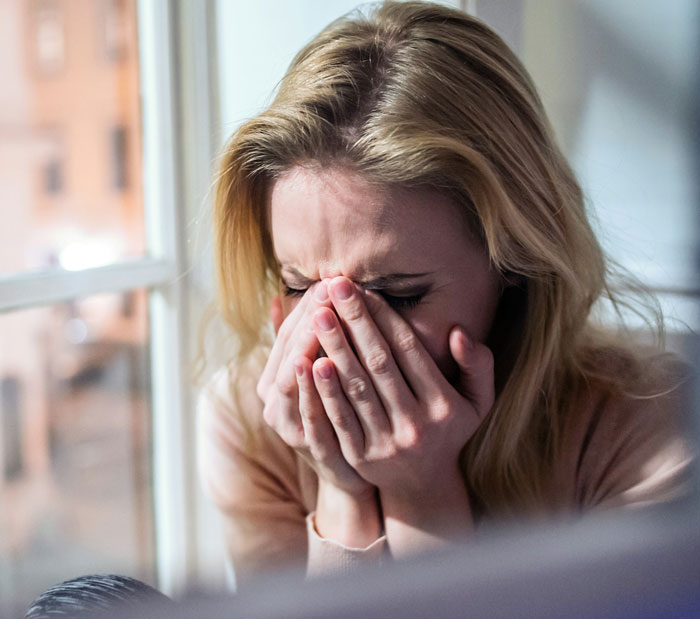 A woman with blonde hair crying, covering her face with her hands, symbolizing the kids reaction to their entitled aunt. A woman with blonde hair crying, covering her face with her hands, symbolizing the kids reaction to their entitled aunt.