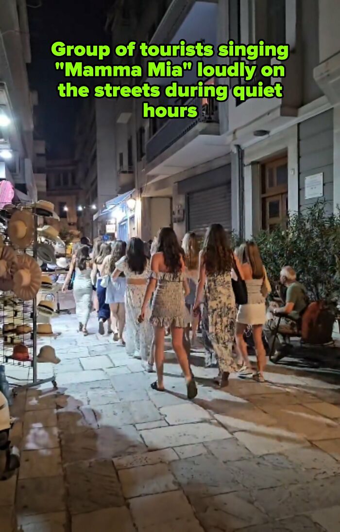 Tourists singing loudly on a quiet street, a clear example of main character tourists.