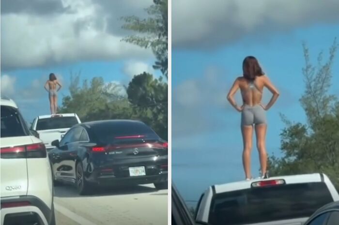 A woman standing on top of a truck in traffic, demonstrating people who think they are the main character.