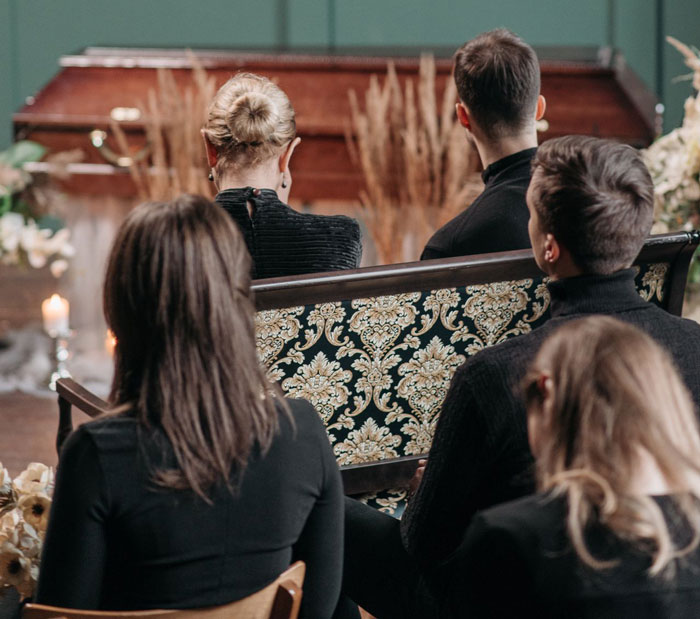 Attendees at a funeral service, a glimpse into the great-grandma's trolling beyond the grave. Attendees at a funeral service, a glimpse into the great-grandma's trolling beyond the grave.