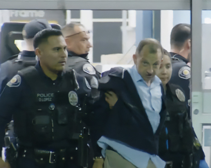 Police officers arresting a man, highlighting the theme of stupid arrests that made us lose faith in humanity.