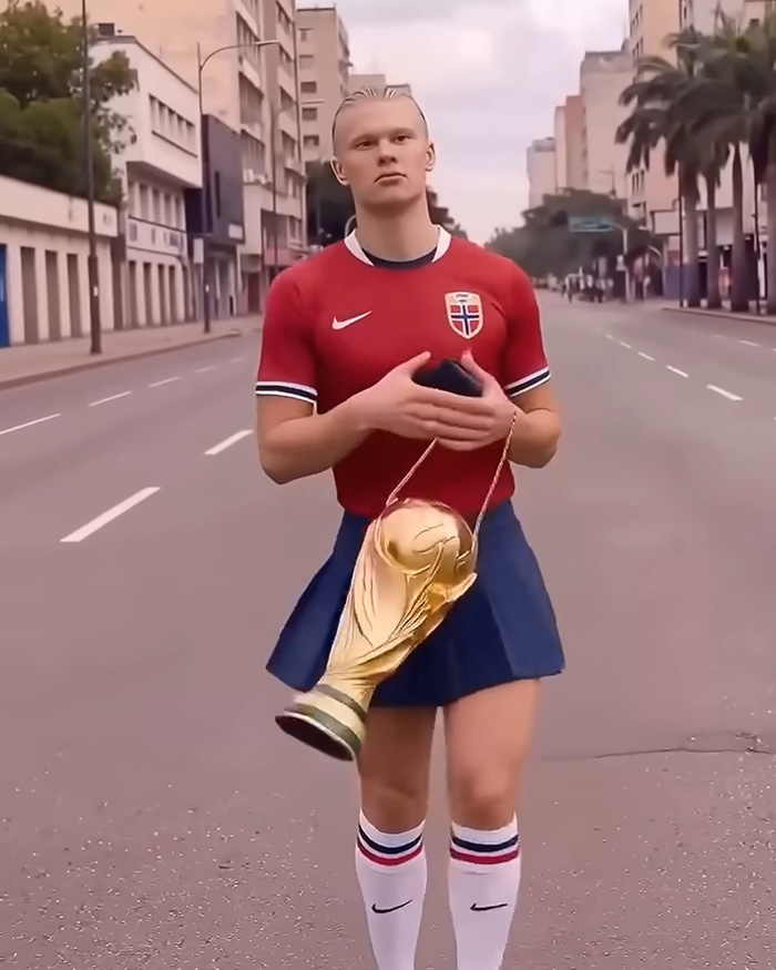 Erling Haaland walking down a street in a red jersey and blue skirt, holding a golden trophy bag, featured in internet memes.