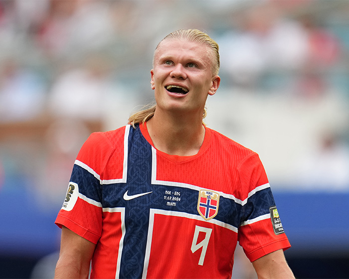 Erling Haaland on the field, smiling, representing his team, responding to internet memes.