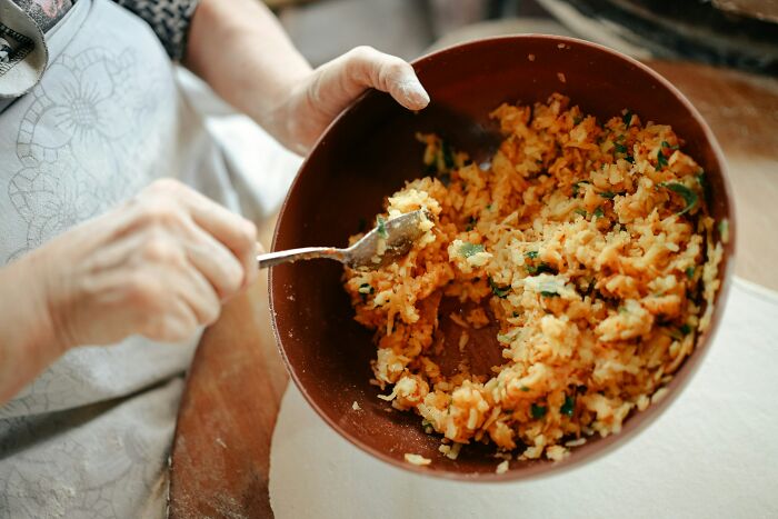 A person mixing food in a bowl, showing everyday items for completely different things.