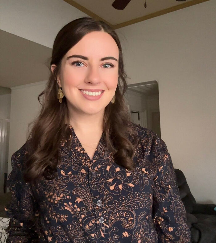 A smiling woman with long brown hair and a patterned shirt, whose looks don't match surprising facts.