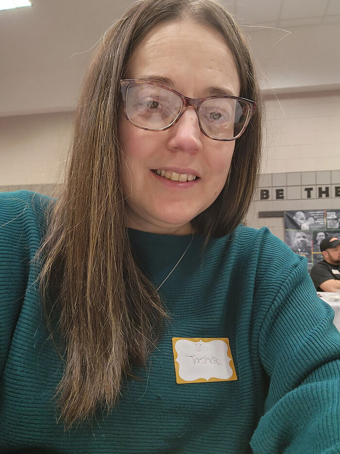 A woman with glasses and long hair smiles, reflecting surprising facts that dont match peoples looks.