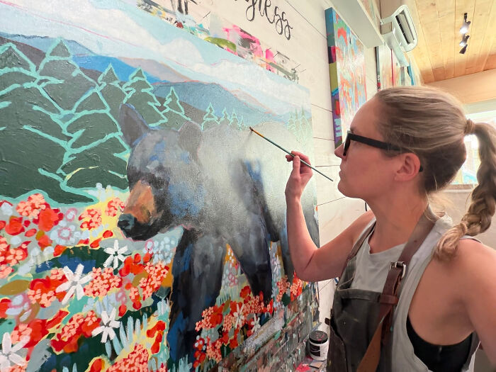 An artist painting a bear, highlighting surprising facts that don't match people's looks.