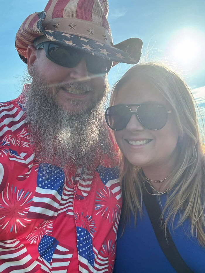 A man with a long beard and an American flag hat, posing with a woman, both having surprising facts about their looks.