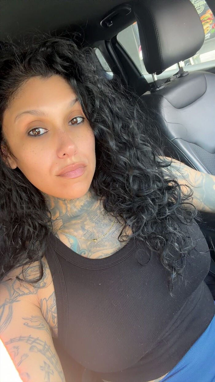 A woman with tattoos on her neck and arms, looking directly at the camera, showing surprising facts about people's looks.
