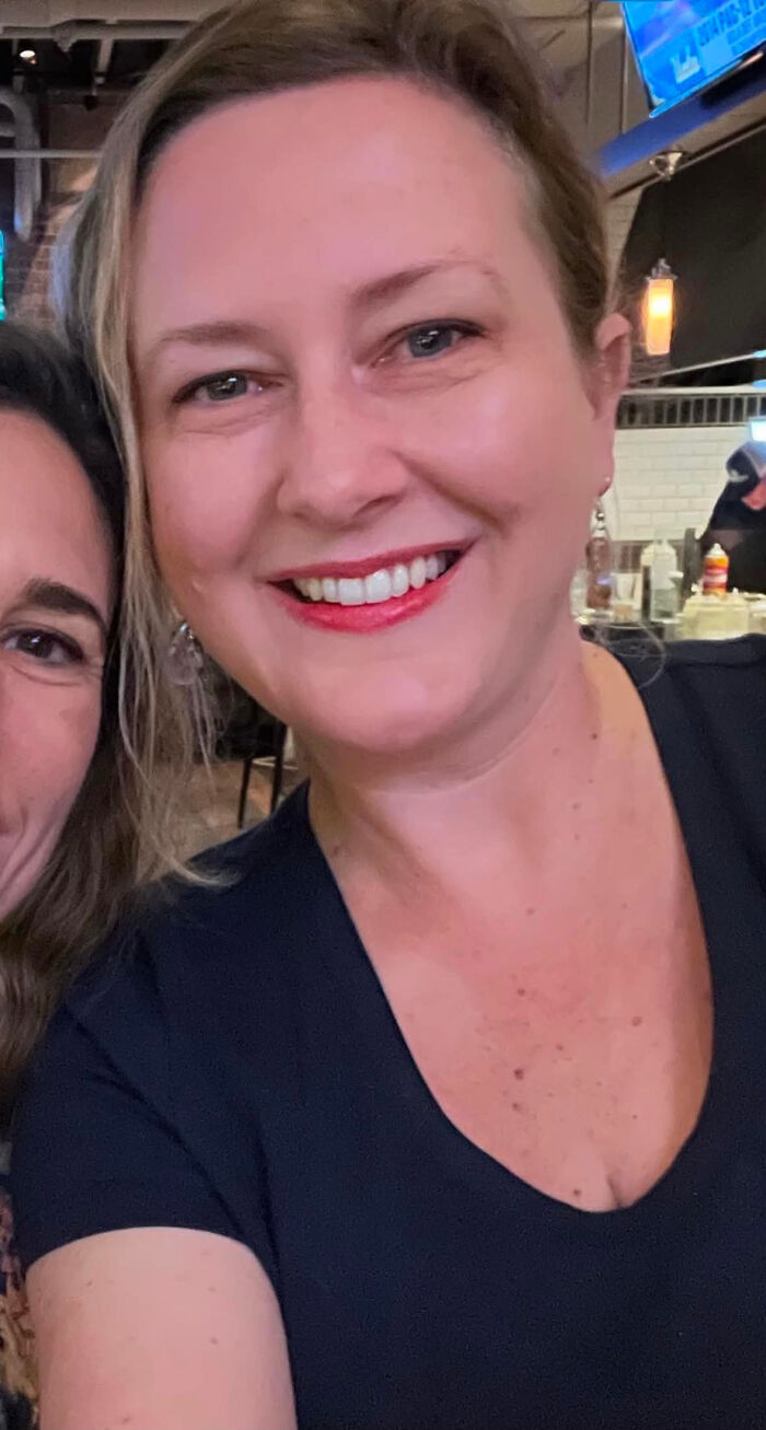 A smiling woman with blonde hair and red lipstick, highlighting surprising facts that dont match people's looks.