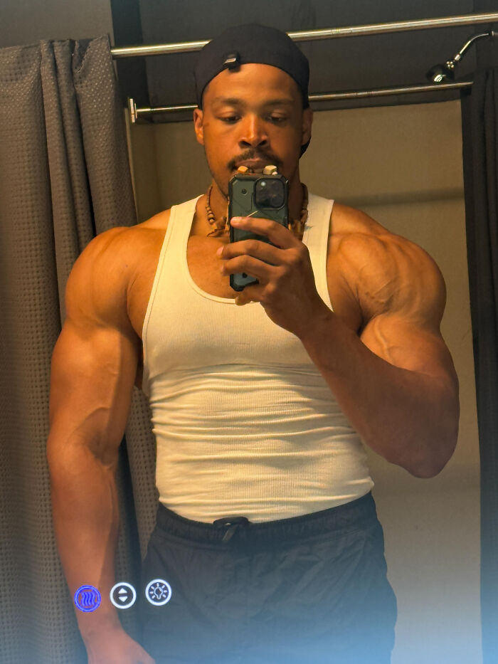 A muscular man taking a mirror selfie, a surprising fact that doesn't match his looks at all.