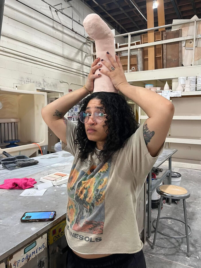 A woman with curly hair balancing a large, pale object on her head. Surprising facts about people's looks.