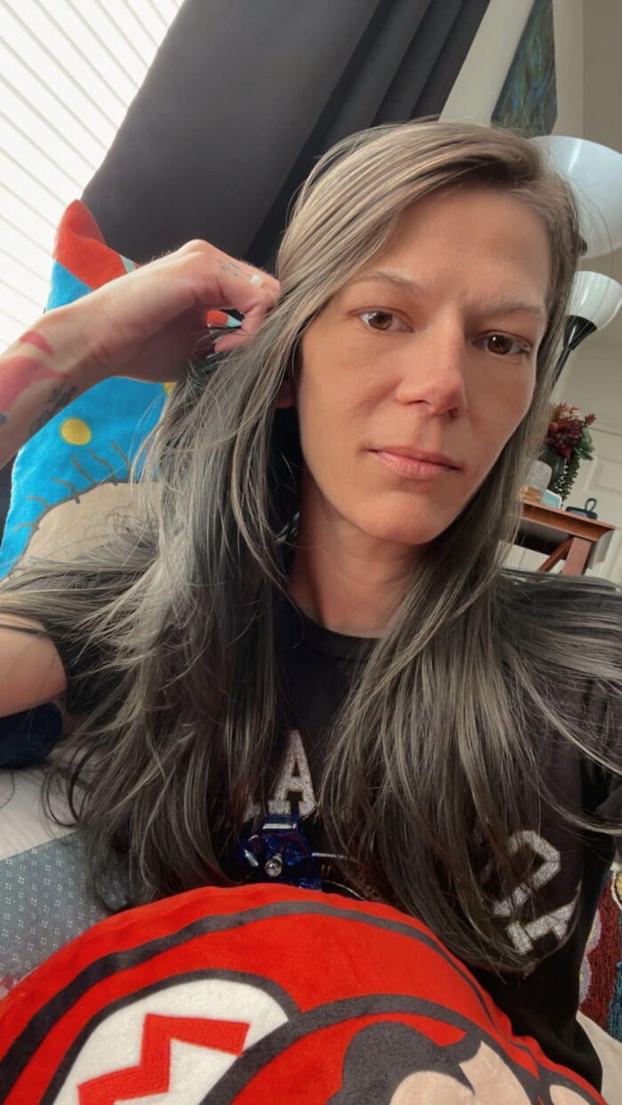 A woman with long gray hair looking intently, revealing surprising facts that dont match her looks.