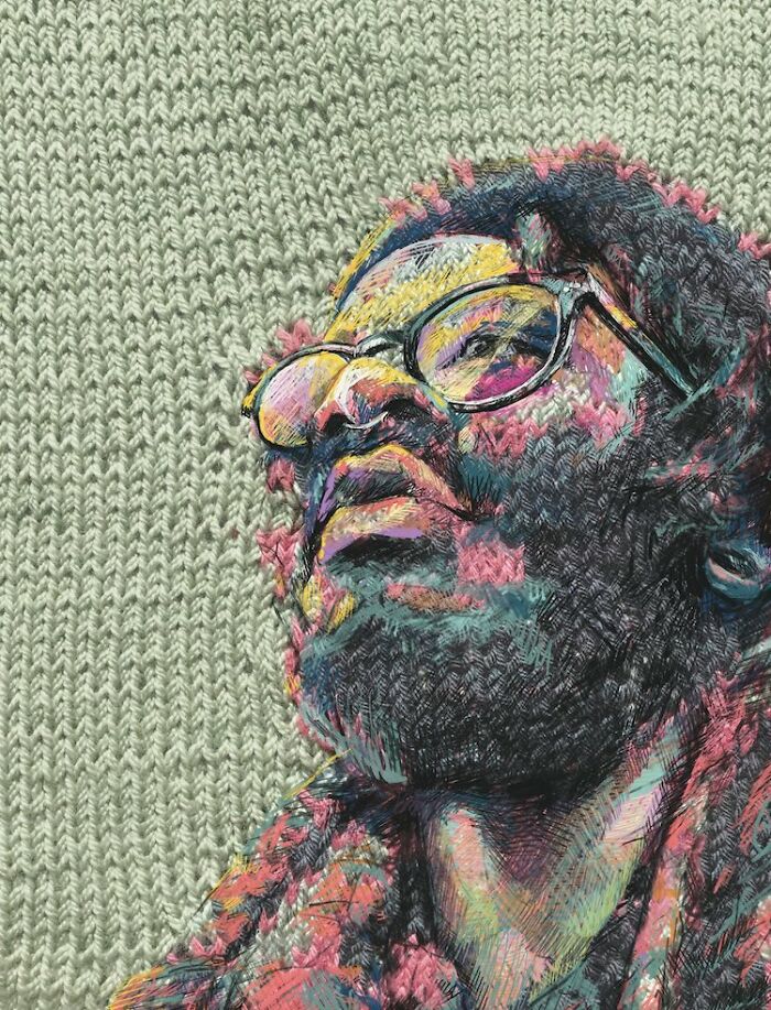 A man with glasses and a beard, looking upwards, rendered through traditional knitting and modern art.