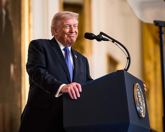 Donald Trump at a podium, smiling, after trolling Taylor Swift. Donald Trump at a podium, smiling, after trolling Taylor Swift.