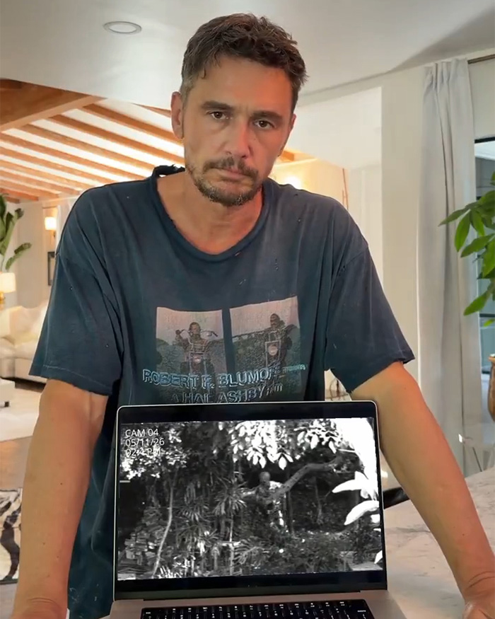 James Franco looking down at a laptop displaying a blurry alien reveal video. James Franco looking down at a laptop displaying a blurry alien reveal video.