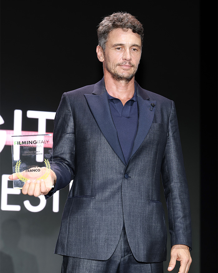 James Franco holding an award, potentially related to his alien reveal video. James Franco holding an award, potentially related to his alien reveal video.