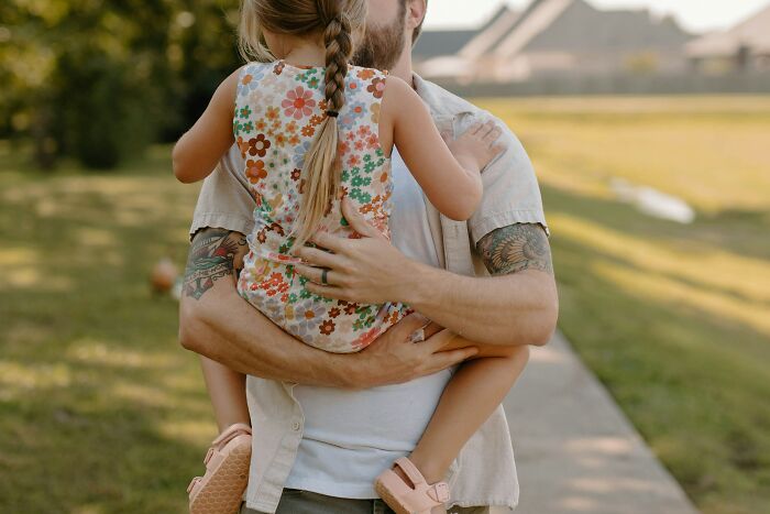 A dad holding his daughter, showing how dads views of women changed.