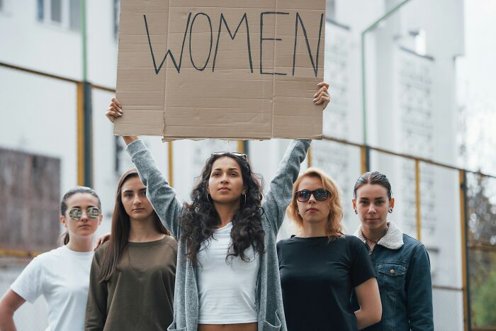 Group of women protesting, advocating for womens rights and changing views and understanding.