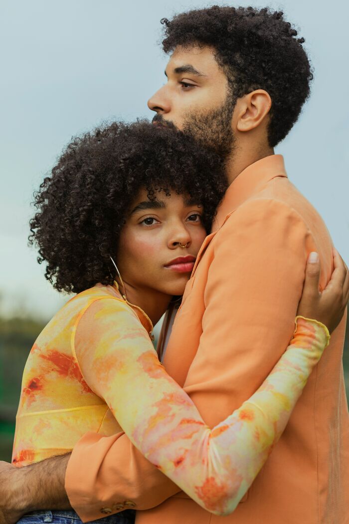 A couple embracing outdoors, reflecting a deep bond and commitment before getting married.