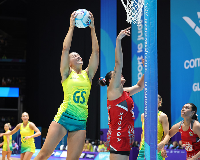 Female athletes in unusual uniforms playing netball, highlighting potential wardrobe malfunctions during the match.