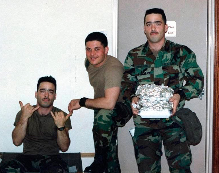 Three Army veterans in camouflage uniforms, two holding food, related to a Walmart parking lot dispute. Three Army veterans in camouflage uniforms, two holding food, related to a Walmart parking lot dispute.