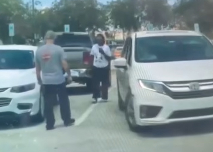Blurry image of an Army veteran and a woman in a Walmart parking lot before a furious dispute. Blurry image of an Army veteran and a woman in a Walmart parking lot before a furious dispute.