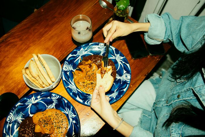 A person eats a meal alone, signifying a moment of realization for divorced people that their marriage was over.