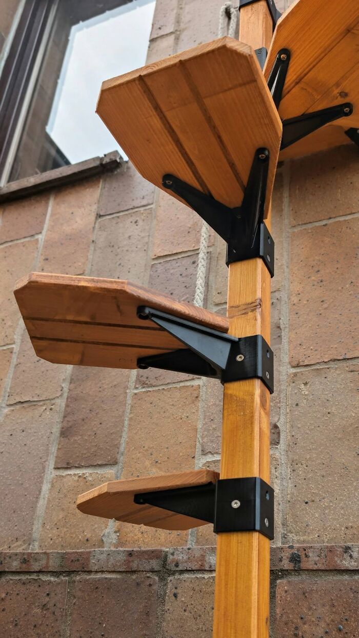 A 3D printed multi-tier cat climbing post attached to a wooden beam, a cool 3D printer creation.