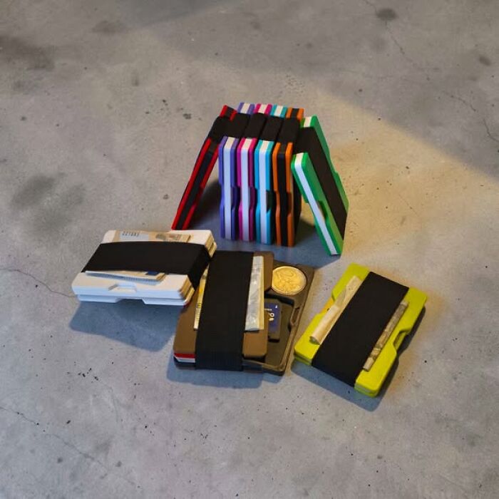 A collection of colorful 3D printed minimalist wallets with elastic bands, displaying functional and cool things created using a 3D printer.