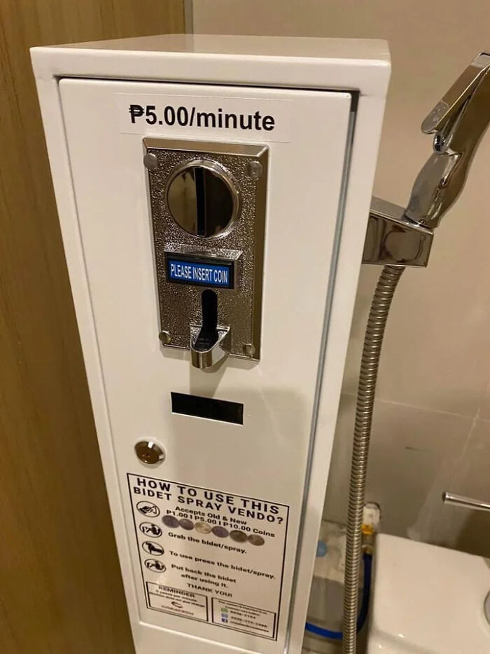 A coin-operated bidet spray dispenser, charging P5.00/minute, highlighting a terribly designed bathroom feature.
