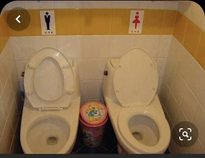 Two toilets side-by-side with gender signs above, illustrating terribly designed public bathrooms with no privacy.