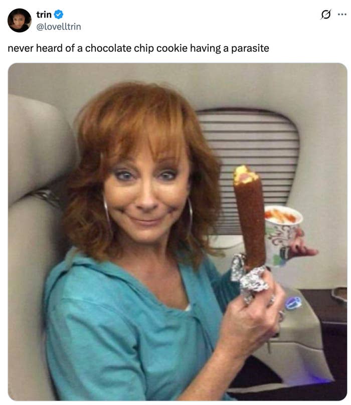 A funny tweet with a woman making a strange face, holding a chocolate chip cookie and a cup.