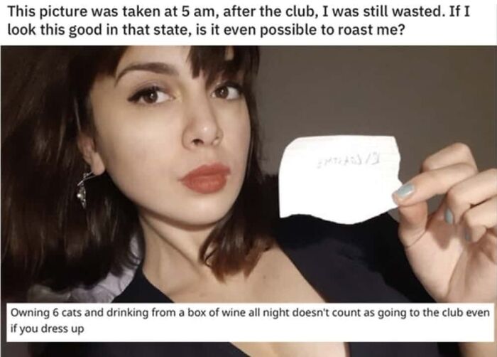 A woman holds a small piece of paper, with a clever clapback about her not actually going to a club.