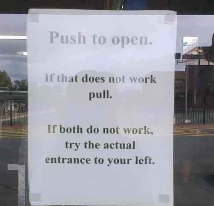 A hilariously failed sign on a glass door providing confusing instructions: Push, Pull, or try the actual entrance.