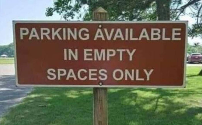 A hilariously failed sign states Parking Available In Empty Spaces Only, showcasing a humorous sign failure.