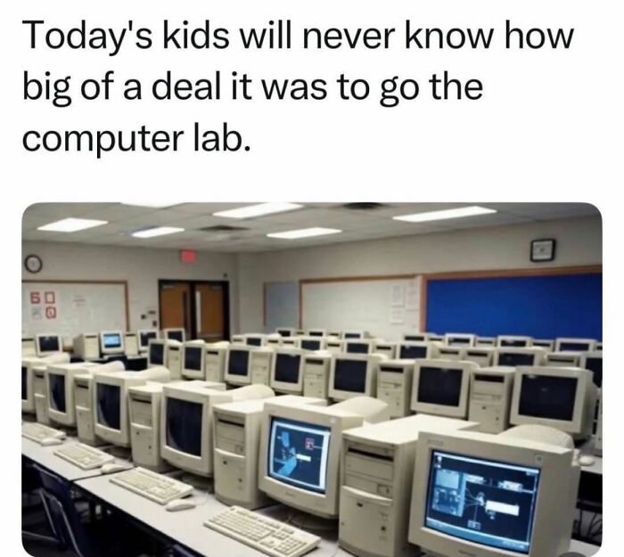 A classroom filled with old computer monitors and keyboards, a memorable Gen X computer lab experience.