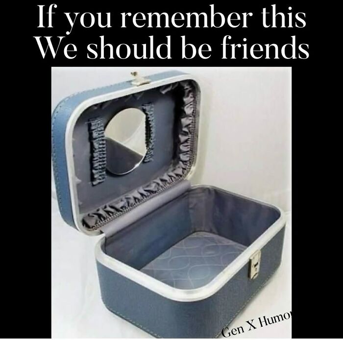 An open, empty blue vanity case with a small mirror inside. This Gen X meme is a nostalgic memory for many.