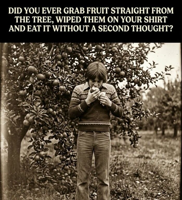 A vintage photo of a boy eating an apple directly from a tree, illustrating a Gen X childhood memory.