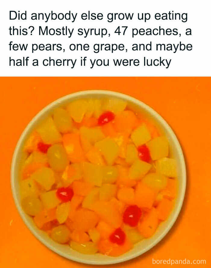 A bowl of fruit cocktail with peaches, pears, grapes, and cherries, a common Gen X food memory.